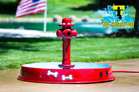 A red dog bowl with a hydrant-style water play feature, designed for outdoor water play. My portable splash pad.