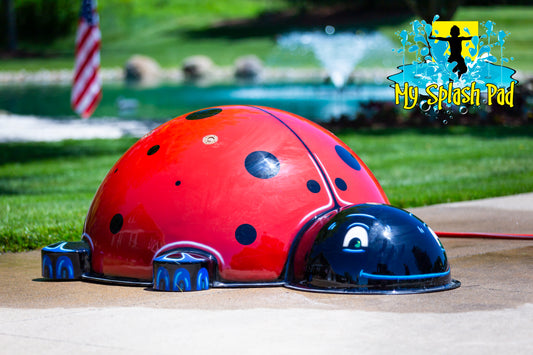 Large Ladybug Mobile Spray and Play Feature by My Splash Pad – bright red and black ladybug-shaped splash pad water play structure installed outdoors.