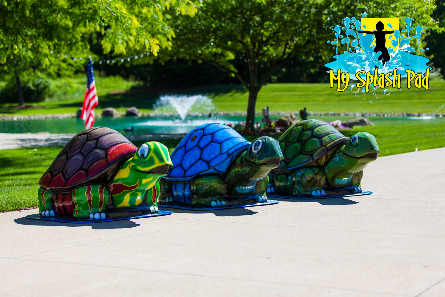 Large Turtle Sprinkler – group of colorful turtle splash pad features in red, blue, and green spraying water for outdoor kids’ play.