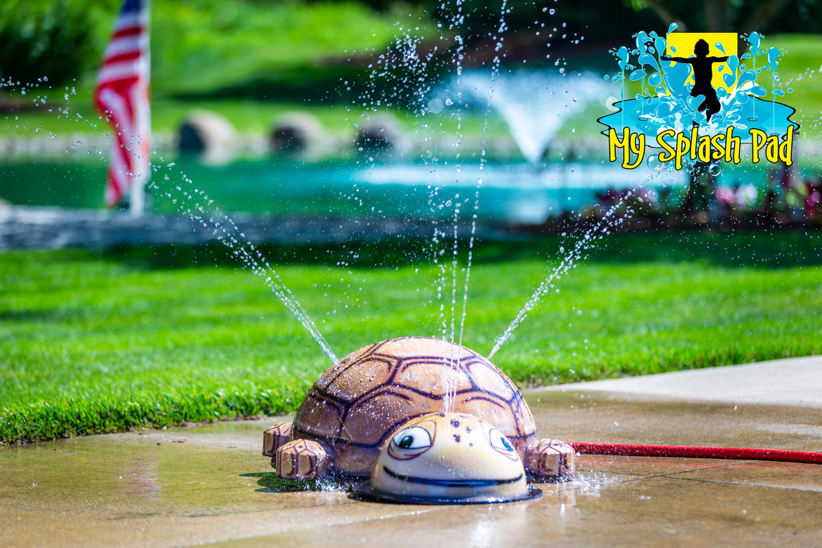 Small Turtle Portable Splash Pad feature with brown shell spraying water streams in a backyard play setting.