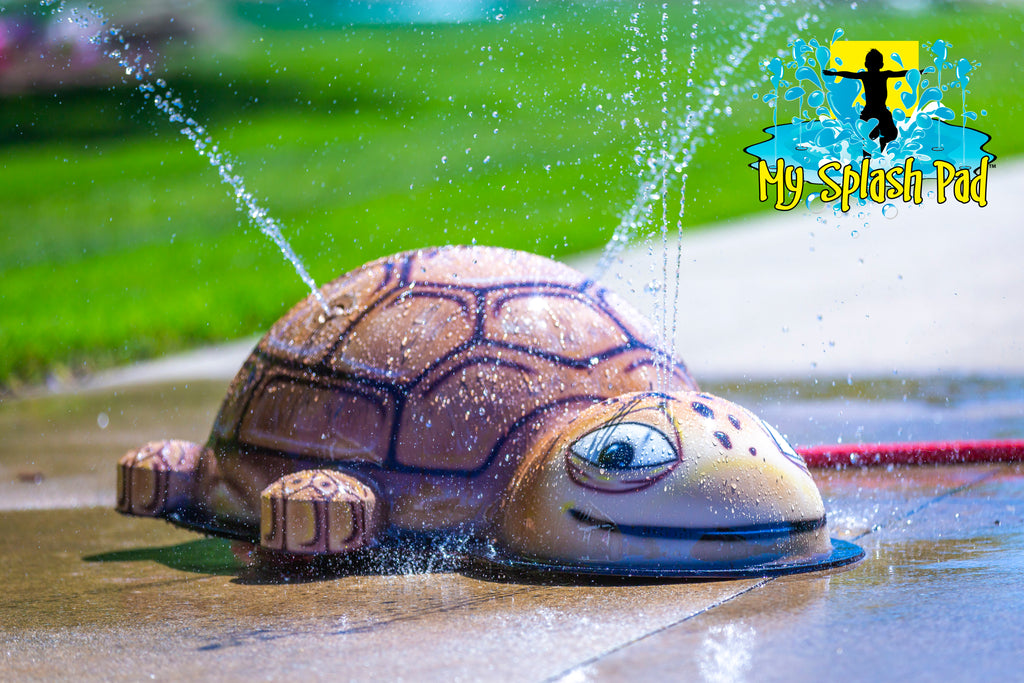 Small Turtle Portable Splash Pad water play feature with brown shell spraying water streams for kids’ backyard fun.