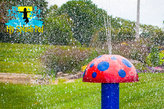 Mini Mushroom Portable Splash Pad water play feature with red mushroom cap and blue stem, designed for backyard splash pads.